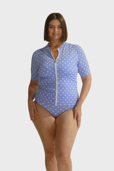Curve model wearing blue and white Polkadot chlorine resistant short sleeve rash vest with front zip