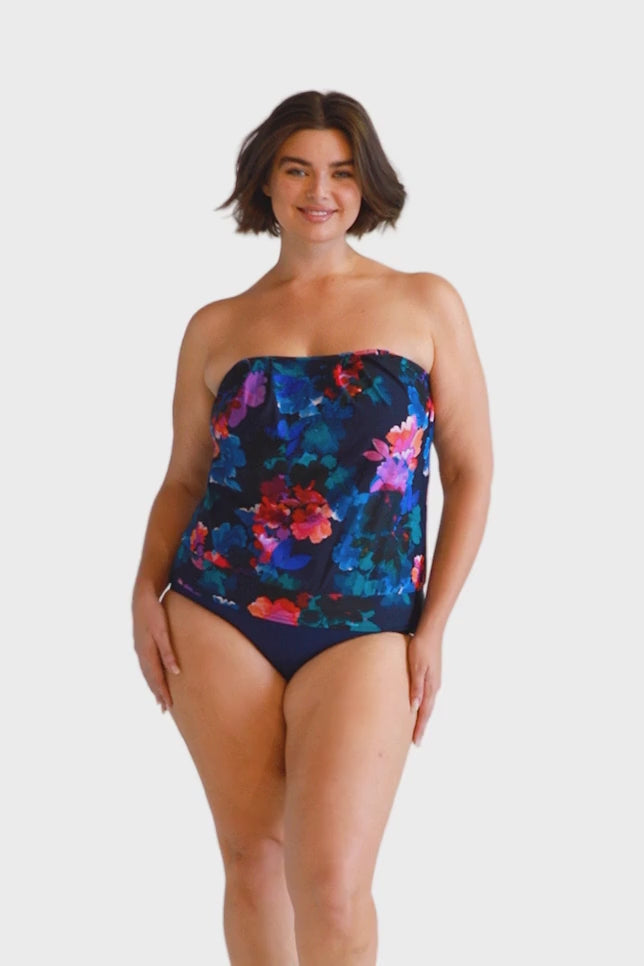 Brunette model navy floral flouncy strapless tankini