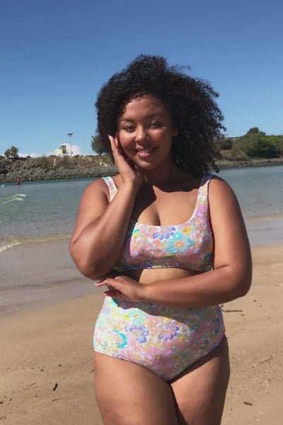 Video of curvy model wearing multi coloured reversible bikini top with tie detail