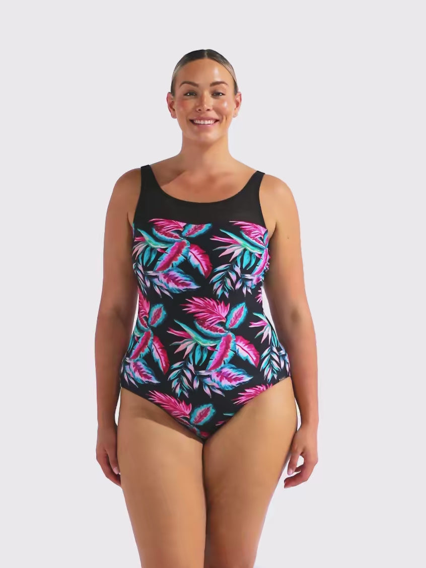 Model in studio wearing a leaf one piece with a high neck and mesh detail