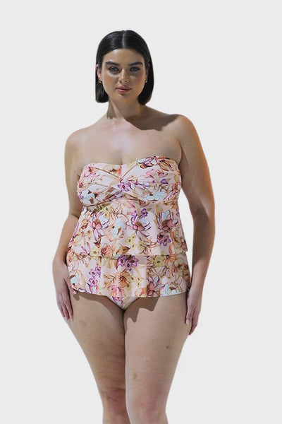 Curve brunette model wearing peach ruffle tankini in tropical floral print