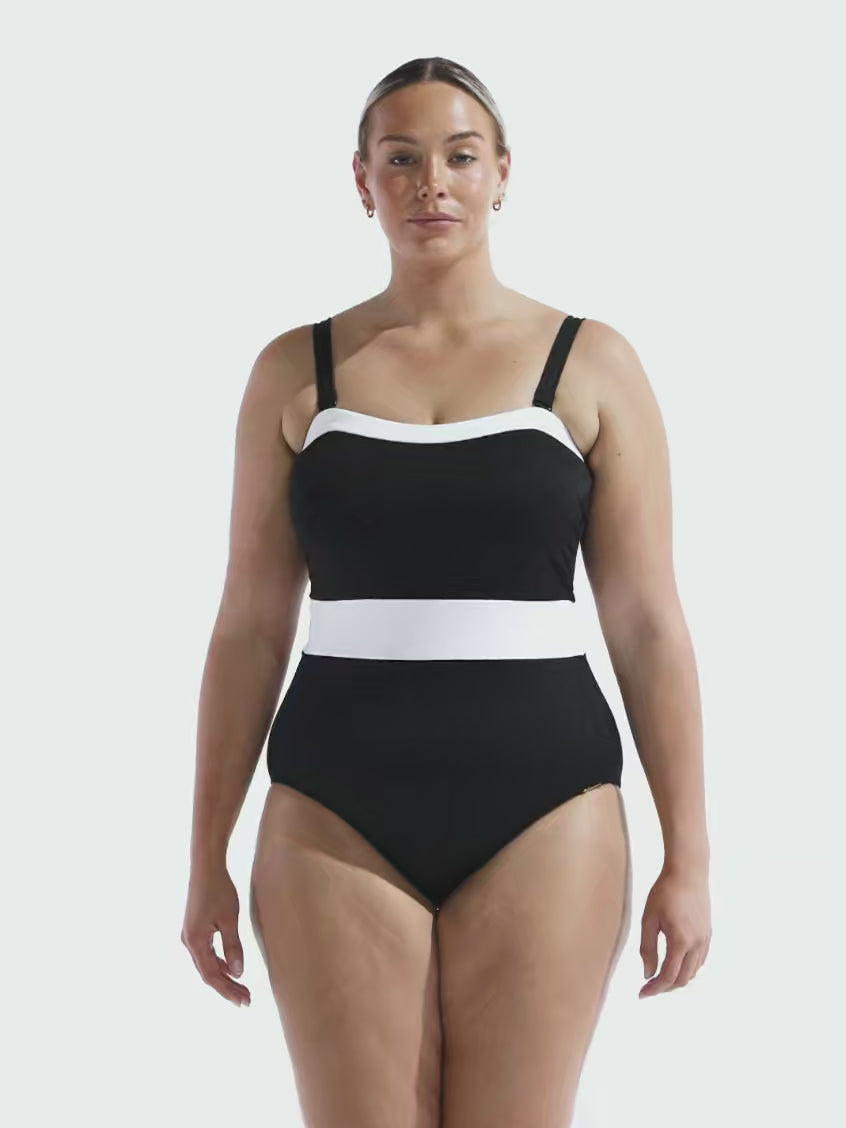Blonde model in studio wearing a plus size one piece with adjustable straps