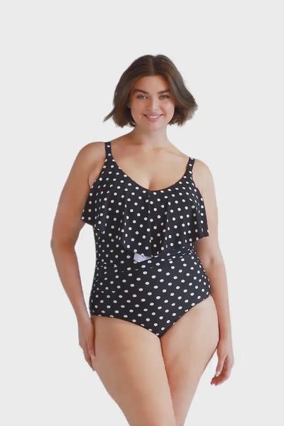 Video of curve model wearing black and white v neck swimsuit with ruffle