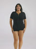 Brunette model in studio wearing a short sleeve boyleg one piece with zip front detail