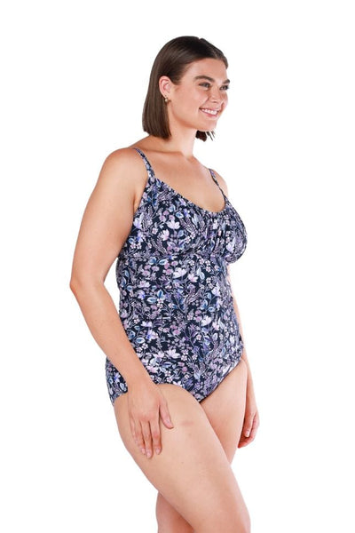 Curve model wearing ruched underwire tankini top in purple floral