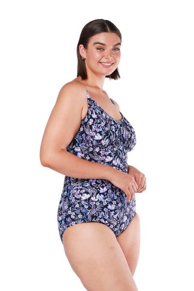 Brunette model wearing floral underwire one piece in navy floral 