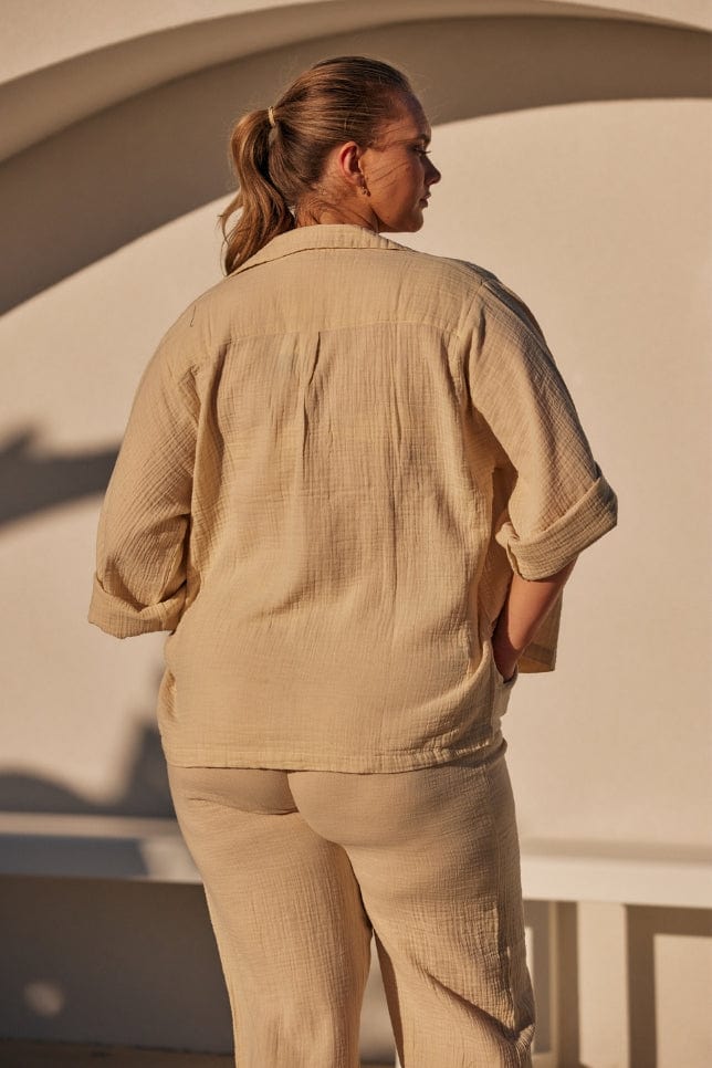 back of blonde model wearing a sand collared lounge wear set