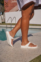model wearing white slip on rubber sandals