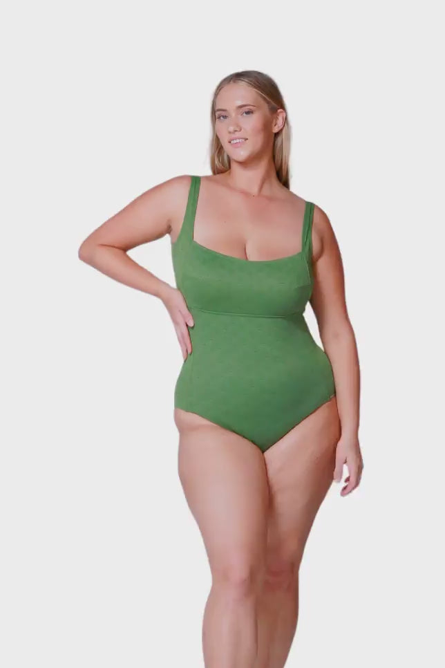 plus size blonde women wearing olive green textured one piece with square neckline
