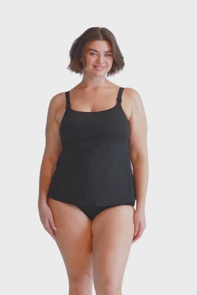 Brunette plus size model wearing black scoop neck chlorine resistant tankini