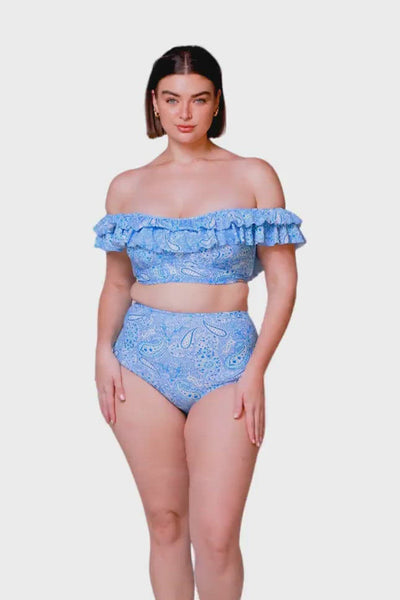 brunette model wearing off the shoulder frilly bikini top in blue paisley with a matching high waisted swim bottom