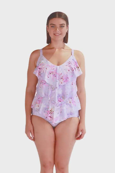 Video of model wearing floral tankini with ruffle detail and tones of purple and pink