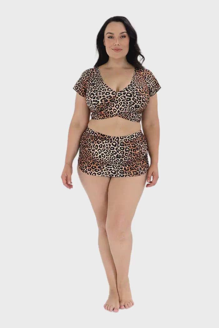 Video of model wearing animal print wrap crop top