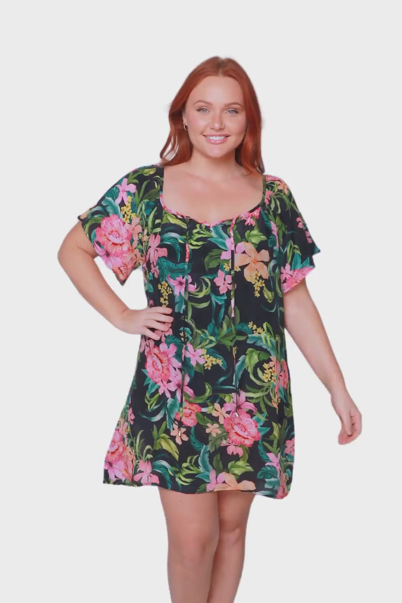 redhead model wears tropical green floral lightweight beach throw on