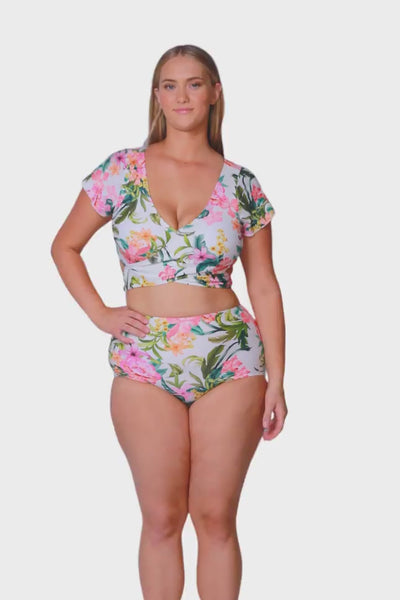 Video of plus size model wearing colourful tropical high waisted bikini bottoms