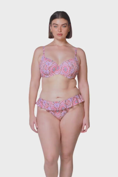 Brunette model wearing pink bikini bottoms