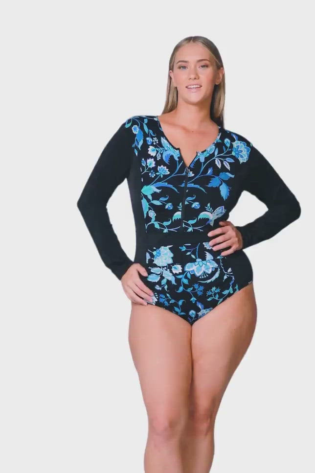 product video of model wearing chlorine resistant long sleeve swimsuit in black with blue floral details