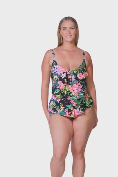 blonde plus size model wears green tropical print one piece with 3 tiers on the front