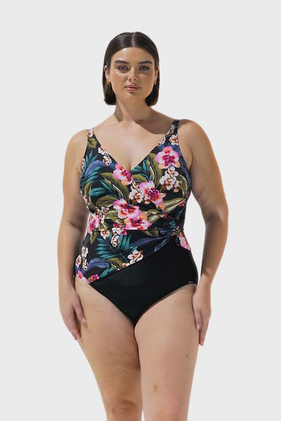Video of curve model wearing black floral v neck crossover swimwear