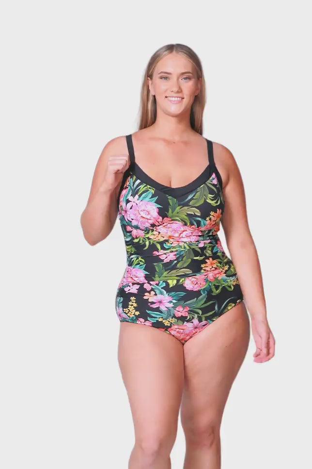 plus size blonde model wears tropical floral one piece with underwire support