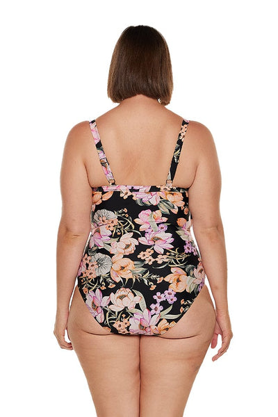 brunette women wears full coverage black floral one piece with adjustable straps