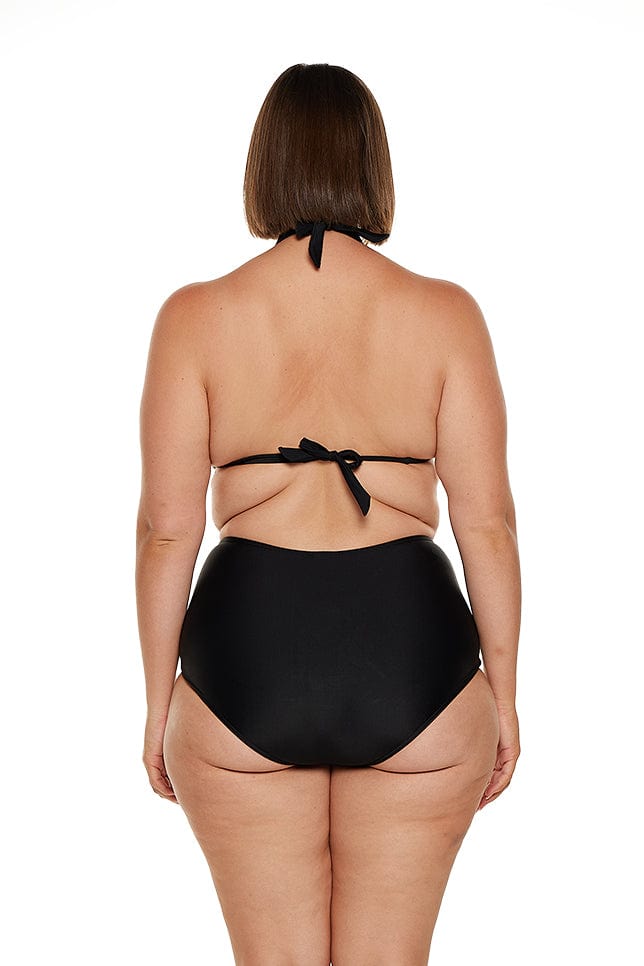 Brunette plus size model wears black halter neck bikini swim top