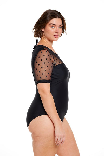 Brunette plus size model wears black modest one piece with mesh polkadot short sleeves