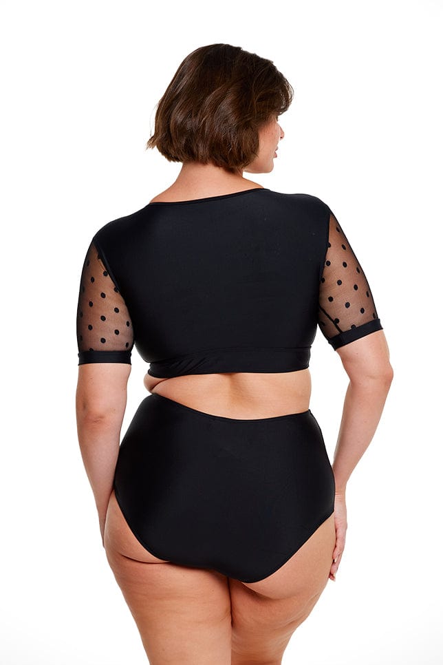 Brunette women wears black short sleeve crop bikini top mesh polkadot