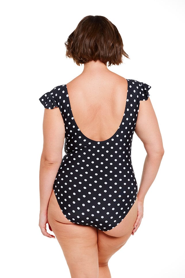 Back of brunette curve women wearing scoop back black and white dots swimsuit Australia