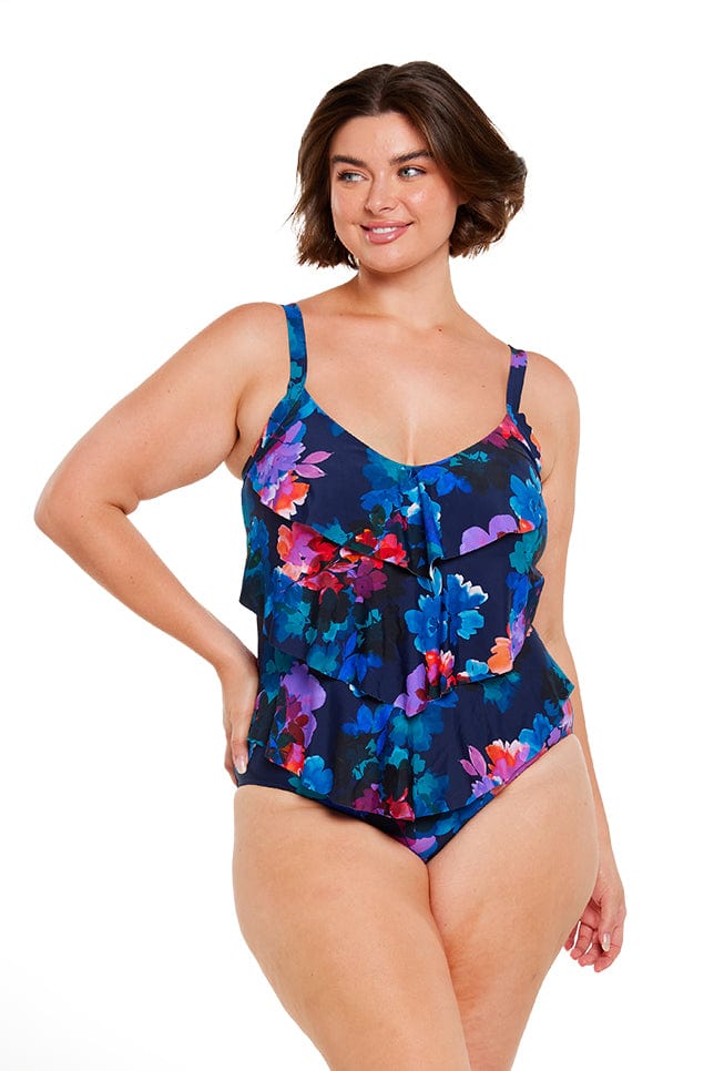 Brunette women wears Navy Blue One Piece with flattering 3 tier ruffle detail