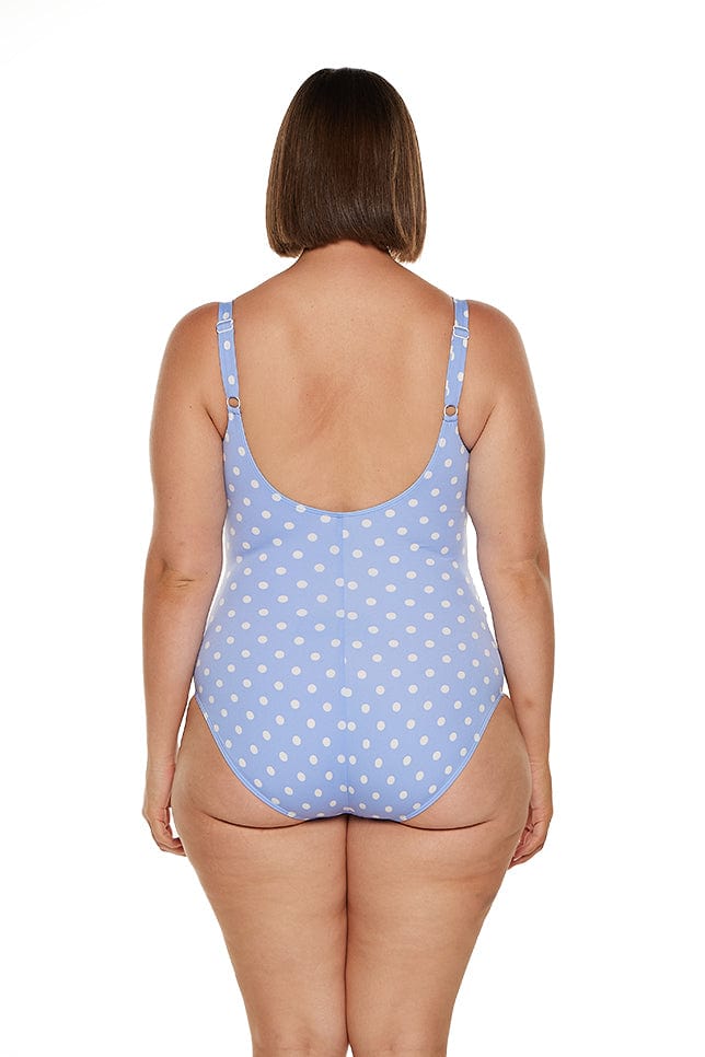 Brunette model wears sporty blue polkadot low back one piece swimsuit in chlorine resistant fabric