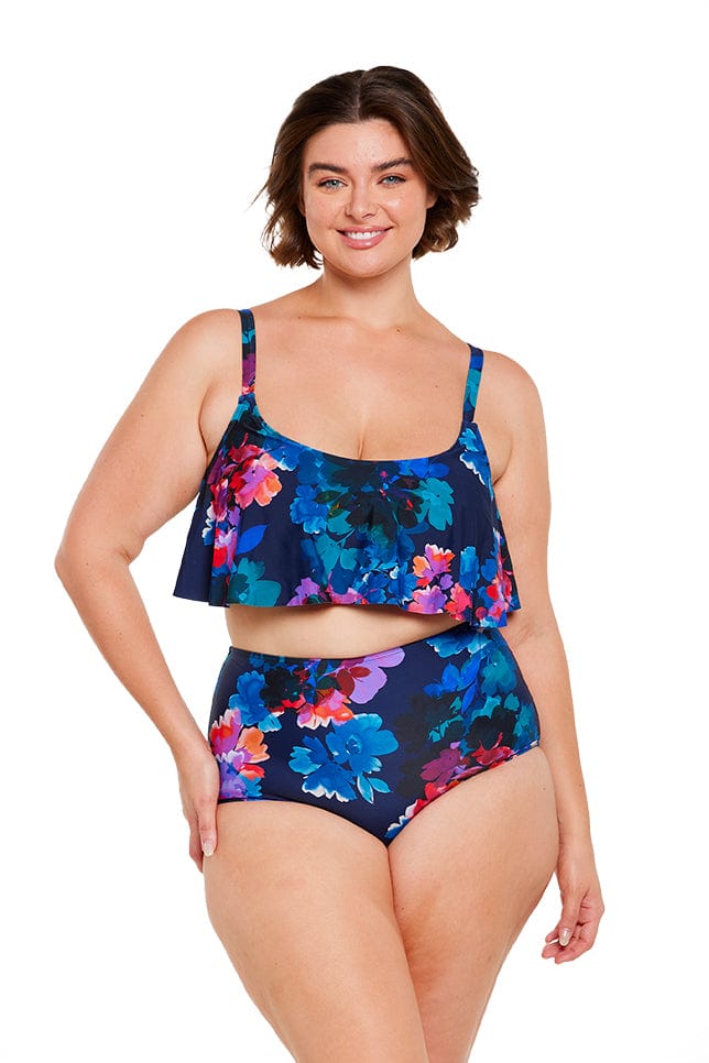 Brunette women wears navy blue floral high waisted swim pant