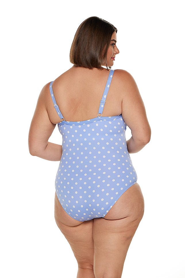 brunette women wears blue dotted one piece in chlorine resistant fabric