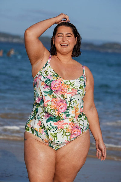 Brunette plus size woman wearing tropical 3 tier ruffle one piece