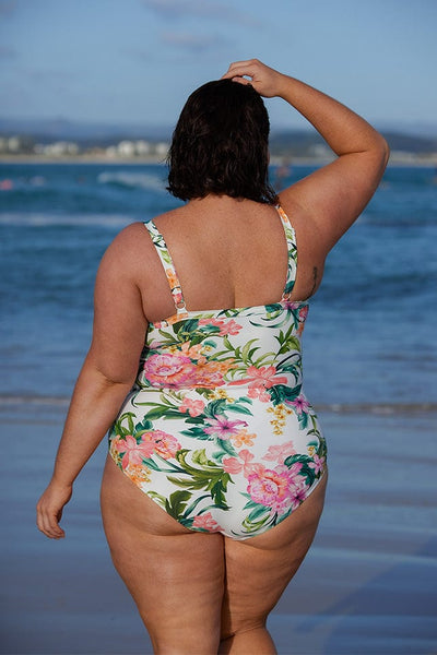 Woman wearing tropical floral ruffle one piece australia