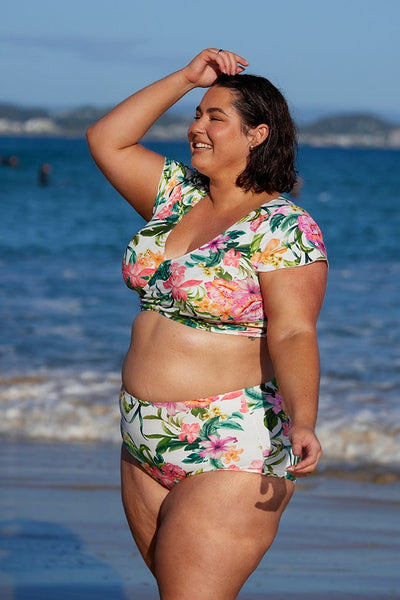 Plus size model wearing high waisted flattering bottoms in white tropical floral