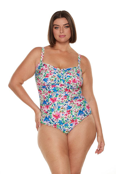 brunette model wears bandeau one piece with removable straps in vibrant floral print