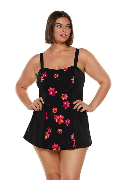 brunette model wears pink and black floral chlorine resistant swim dress with no pant