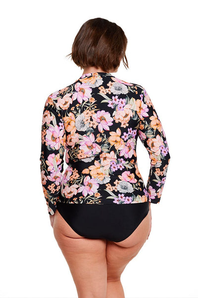 Brunette model wears black floral rash vest with full length sleeves