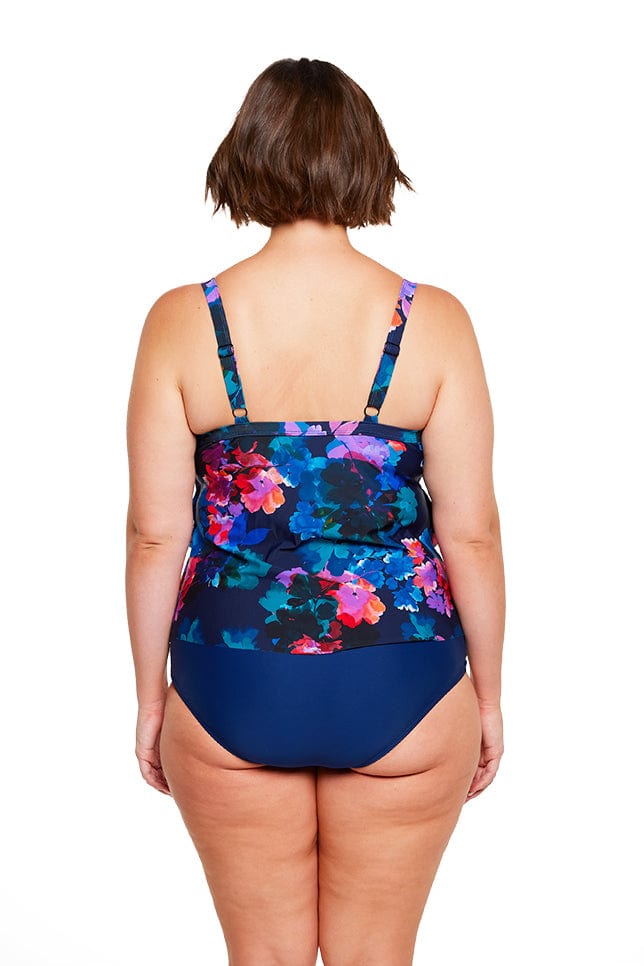 Brunette model wears navy floral flattering tankini top with adjustable straps