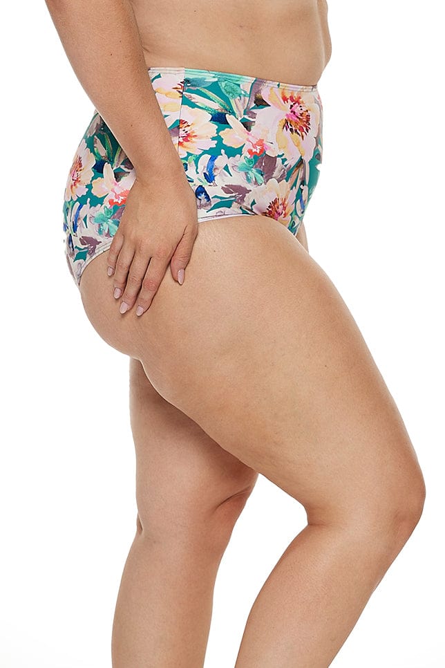 model wears high waisted tummy control swim bottom in green floral