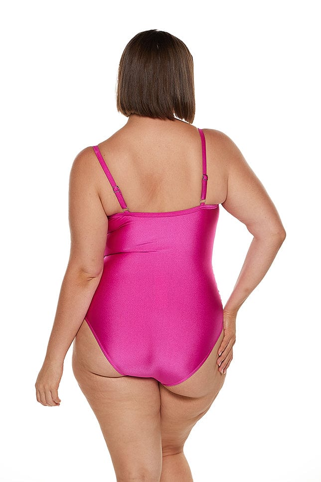 Brunette model wears full coverage hot pink one piece swimwear australia