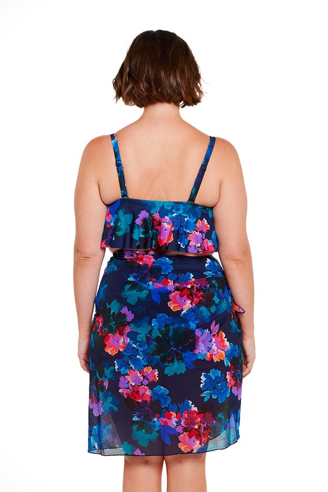 Brunette model wears navy blue floral lighweight mesh wrap skirt 
