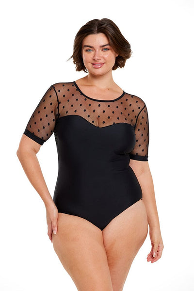 Brunette model wears black sweetheart neck one piece with mesh polkadot sleeves