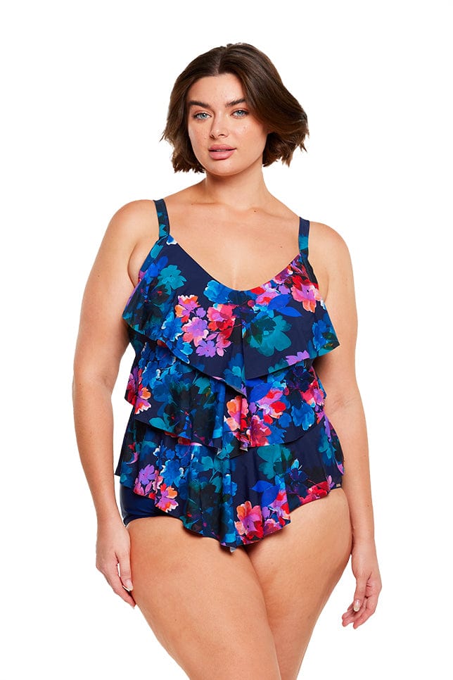 Brunette model wears navy blue floral ruffled 3 tier tankini top