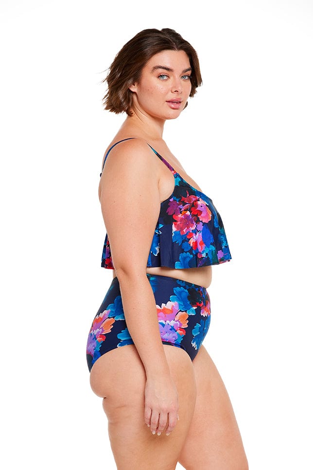 Plus size brunette model wears navy blue floral high waisted bikini bottom