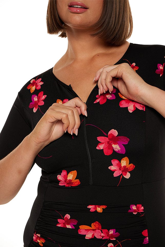 Model wears pink floral chlorine resistant zip front one piece