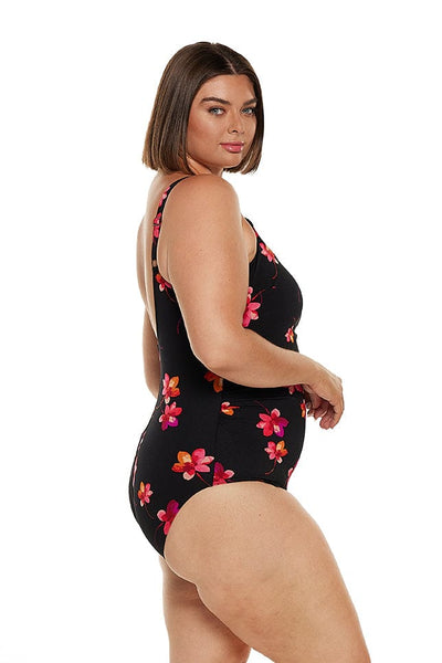 brunette women wearing black chlorine resistant one piece with pink florals