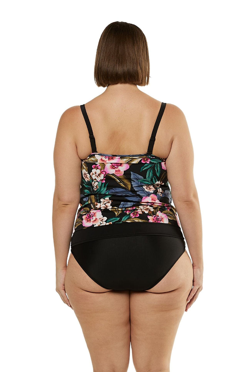 Back of brunette model wearing tankini top with bra support and black floral print