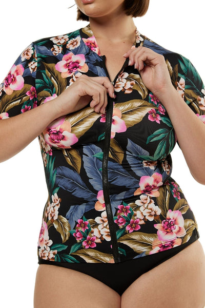 Close up details of model wearing plus size rash vest with short sleeves in black floral